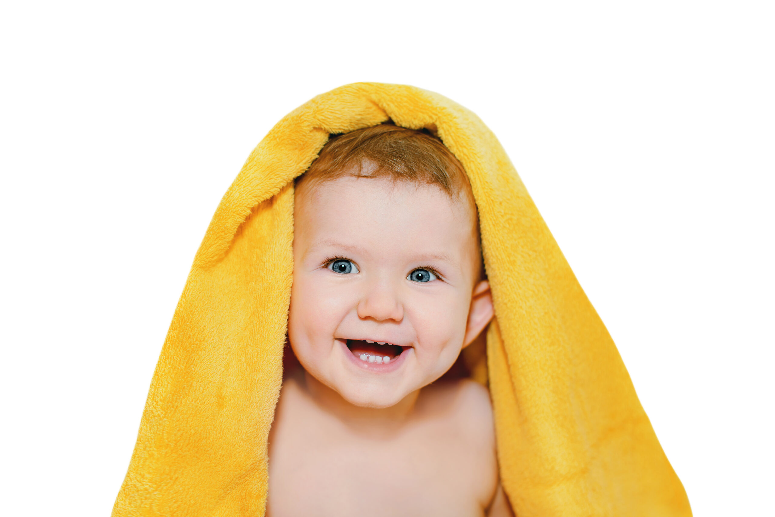 Happy little baby under a yellow towel isolated in white background.